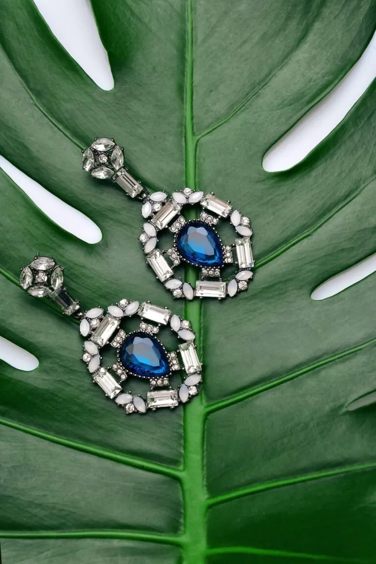Statement earrings on a leaf